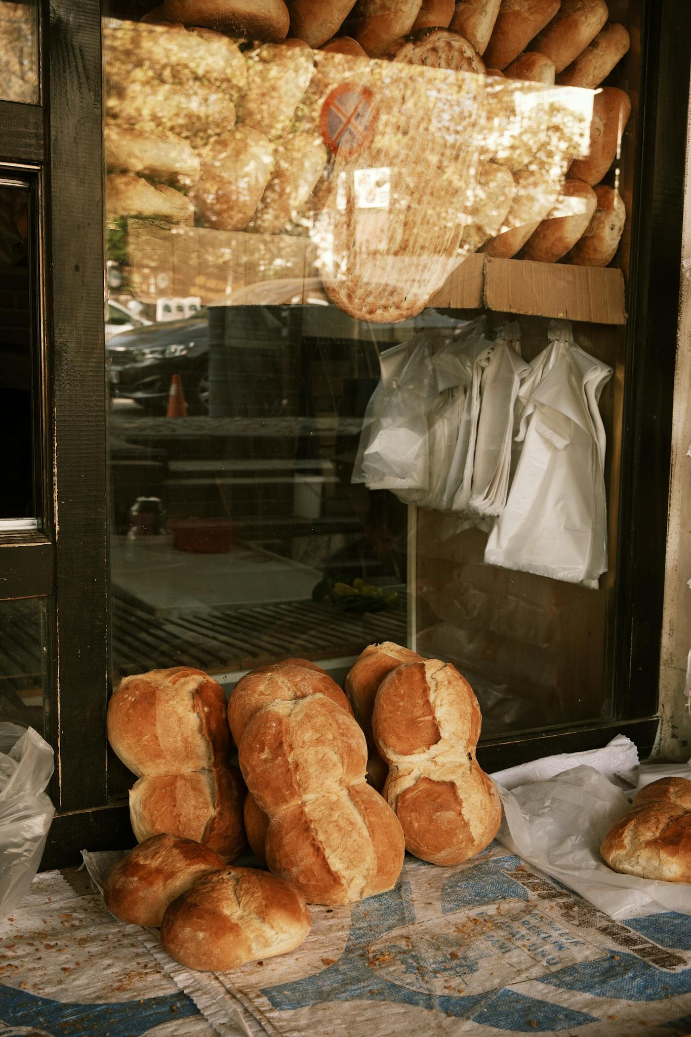 Close-up of fresh loaves on display outside a bakery.