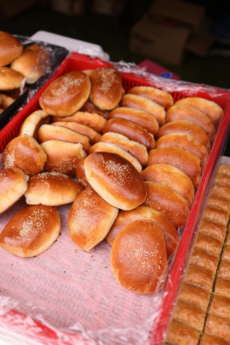 Delicious variety of sweet buns on display at a traditional market stall. Perfect for bakery or food theme.